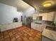 Spacious kitchen with stainless steel appliances, stylish cabinets, and unique terracotta tile flooring at 6171 Whispering Sands Dr, Las Vegas, NV 89131