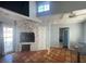 Cozy living room with stone fireplace, double-height ceiling, and terracotta tile flooring at 6171 Whispering Sands Dr, Las Vegas, NV 89131
