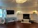 Cozy living room with fireplace, hardwood floors, and recessed lighting at 6171 Whispering Sands Dr, Las Vegas, NV 89131