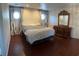Spacious bedroom featuring hardwood floors, custom curtains, and a large dresser at 6171 Whispering Sands Dr, Las Vegas, NV 89131
