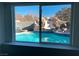 Enjoy the sparkling backyard pool with a slide feature, visible from the window at 6171 Whispering Sands Dr, Las Vegas, NV 89131