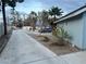 Long side yard with mature trees, offering a tranquil landscape alongside the property at 6171 Whispering Sands Dr, Las Vegas, NV 89131