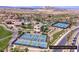 Aerial view of community featuring tennis courts, swimming pool, clubhouse, and scenic desert landscaping at 64 Strada Principale # 307, Henderson, NV 89011