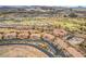 An aerial view of the neighborhood with a golf course and water features at 64 Strada Principale # 307, Henderson, NV 89011