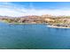 Expansive aerial view of waterfront community with lake, luxurious homes, and mountain backdrop at 64 Strada Principale # 307, Henderson, NV 89011