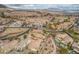 Picturesque aerial view highlighting homes, lush landscaping, and scenic mountain views at 64 Strada Principale # 307, Henderson, NV 89011