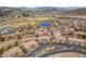 An aerial view of the condominium complex, golf course, and surrounding neighborhood at 64 Strada Principale # 307, Henderson, NV 89011