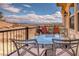 Relaxing balcony area with a dining set, grill, and desert views at 64 Strada Principale # 307, Henderson, NV 89011