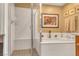 Bright bathroom featuring a shower, soaking tub, and decorative accents at 64 Strada Principale # 307, Henderson, NV 89011