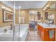 Bright bathroom featuring a soaking tub, glass shower, and a double sink vanity at 64 Strada Principale # 307, Henderson, NV 89011