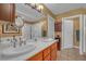 Relaxing bathroom with dual sinks, wood cabinets, framed mirrors and a glass shower at 64 Strada Principale # 307, Henderson, NV 89011