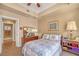 Bedroom featuring a ceiling fan, comfortable bed, and dresser with decorative mirror at 64 Strada Principale # 307, Henderson, NV 89011