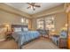 Comfortable bedroom with large window, dark wood bed frame, and neutral colored carpet at 64 Strada Principale # 307, Henderson, NV 89011
