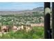 Distant elevated view of a neighborhood with manicured landscaping, homes, and the mountains as a backdrop at 64 Strada Principale # 307, Henderson, NV 89011