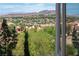 Distant elevated view of a neighborhood with manicured landscaping, homes, and the mountains as a backdrop at 64 Strada Principale # 307, Henderson, NV 89011