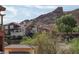 Attractive multi-story home features a charming exterior with manicured landscaping and a dramatic mountain backdrop at 64 Strada Principale # 307, Henderson, NV 89011