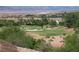 Scenic view of a lush golf course with beautiful homes and mountains in the background on a sunny day at 64 Strada Principale # 307, Henderson, NV 89011