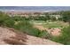 Scenic view of a lush golf course with beautiful homes and mountains in the background on a sunny day at 64 Strada Principale # 307, Henderson, NV 89011