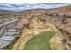 A stunning aerial view of the golf course amidst the desert landscape and houses at 64 Strada Principale # 307, Henderson, NV 89011