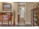 Neutral hallway boasts a display cabinet, console table with decor, and doorway leading to other rooms at 64 Strada Principale # 307, Henderson, NV 89011