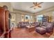 Spacious living room featuring a ceiling fan, comfortable seating, and natural light from large windows at 64 Strada Principale # 307, Henderson, NV 89011