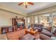 This cozy living room has leather seating, a ceiling fan, plus windows providing great views of the outside at 64 Strada Principale # 307, Henderson, NV 89011