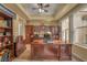 Spacious home office boasts custom built-ins, neutral carpet, a ceiling fan, and a bright window view at 64 Strada Principale # 307, Henderson, NV 89011