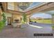 Beautiful outdoor patio with a stone fireplace, comfortable seating, and scenic golf course views at 64 Strada Principale # 307, Henderson, NV 89011