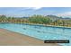 Beautiful turquoise lap pool with mountains in the background and blue sky overhead at the Lake Las Vegas Sports Club at 64 Strada Principale # 307, Henderson, NV 89011