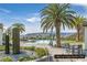 Beautiful pool with mountains in the background surrounded by palm trees and comfortable lounge chairs at 64 Strada Principale # 307, Henderson, NV 89011