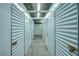 Well-lit storage area with rows of secure, white metal storage units at 64 Strada Principale # 307, Henderson, NV 89011