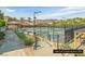 Well-maintained tennis courts with palm trees, mountain views, and charming gazebo seating areas at 64 Strada Principale # 307, Henderson, NV 89011