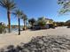 Picturesque waterfront view featuring cobblestone promenade, palm trees, and a bright blue sky at 64 Strada Principale # 307, Henderson, NV 89011