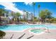 Community pool with spa, lounge chairs, and mature palm trees at 6480 Annie Oakley Dr # 614, Las Vegas, NV 89120