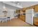 Bright kitchen with adjacent dining area and white appliances at 6603 Vigo Rd, Las Vegas, NV 89146