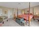 Bright main bedroom featuring carpet, four poster bed, neutral paint and natural light at 6603 Vigo Rd, Las Vegas, NV 89146