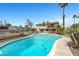 Backyard features a large pool, mature landscaping, and a glimpse of the home at 6603 Vigo Rd, Las Vegas, NV 89146