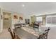 Open-concept dining room with view to living area and sliding glass door at 6814 Willowcroft St # I, Las Vegas, NV 89149