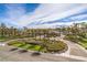 Aerial view of a gated community with lush landscaping, palm trees, and well-maintained streets at 7131 Mission Hills Dr, Las Vegas, NV 89113