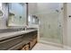 Bathroom boasting sleek gray countertop with stylish cabinets and a frameless shower at 7131 Mission Hills Dr, Las Vegas, NV 89113
