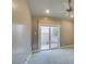 Bright bedroom with a ceiling fan and sliding glass doors leading to an enclosed outdoor space at 7131 Mission Hills Dr, Las Vegas, NV 89113