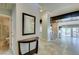 View of the home's entryway with a tiled floor, a hall table and a bathroom at 7131 Mission Hills Dr, Las Vegas, NV 89113