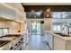 Spacious kitchen features a stainless steel stove, tile backsplash, and a cozy breakfast nook with backyard access at 7131 Mission Hills Dr, Las Vegas, NV 89113