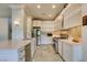 Bright kitchen features white cabinets, stainless steel appliances, and neutral countertops and backsplash at 7131 Mission Hills Dr, Las Vegas, NV 89113