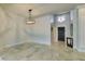 Bright living room features light-colored tiled floors and access to the patio at 7131 Mission Hills Dr, Las Vegas, NV 89113