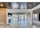 Bright living room features light-colored tiled floors and access to the patio at 7131 Mission Hills Dr, Las Vegas, NV 89113