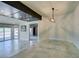Bright living room features light-colored tiled floors and access to the patio at 7131 Mission Hills Dr, Las Vegas, NV 89113