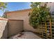 Enclosed patio area features a textured wall, mature flowering shrub, and a concrete floor at 7131 Mission Hills Dr, Las Vegas, NV 89113