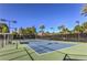 Well-maintained tennis court with professional lighting and surrounding greenery for private enjoyment at 7131 Mission Hills Dr, Las Vegas, NV 89113