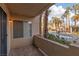 Balcony view of pool, palm trees, picnic tables, and multi story residential buildings in the distance at 7163 S Durango Dr # 108, Las Vegas, NV 89113